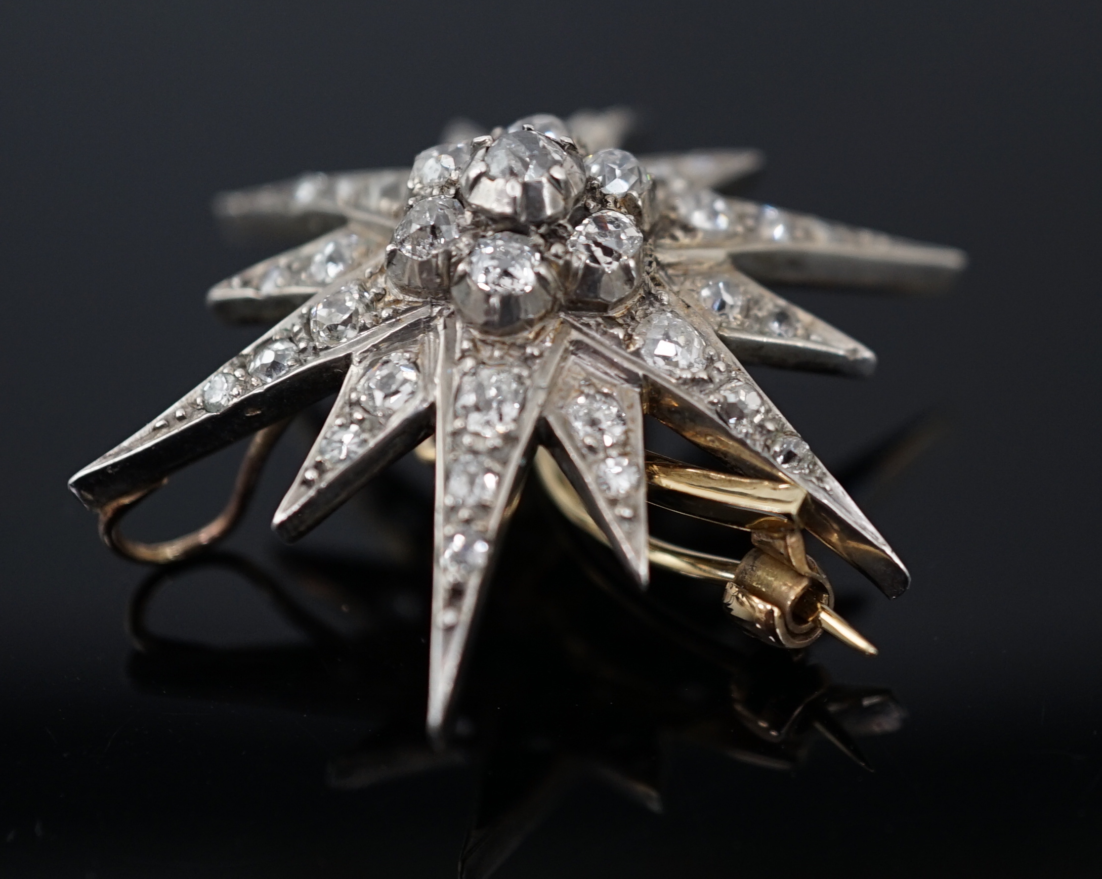 A Victorian gold, silver and graduated diamond cluster starburst brooch